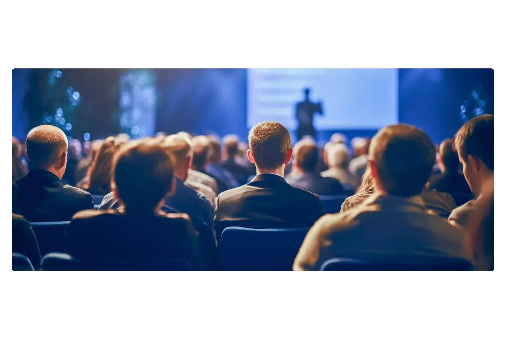 Conference with people looking at the speaker
