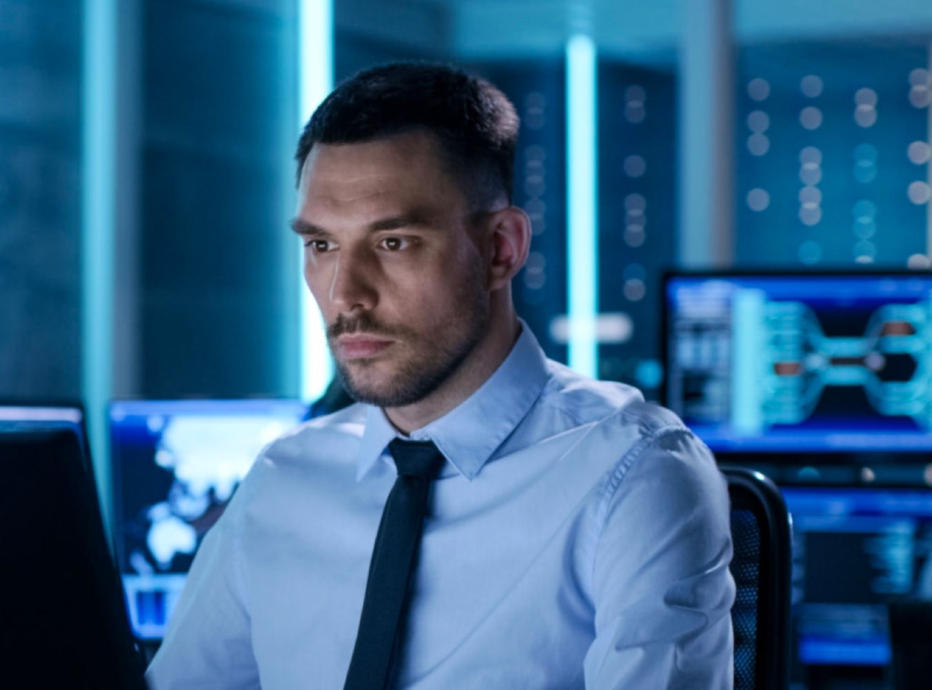 Man in a suit looking at its computer