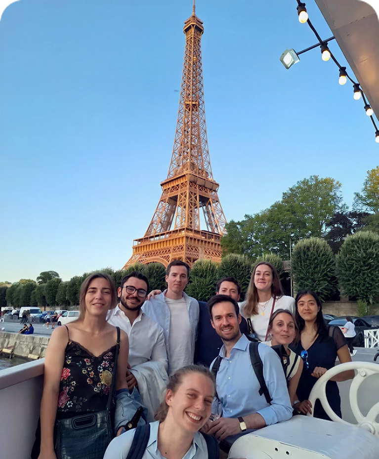 Team of people in front of the Eiffel Tower